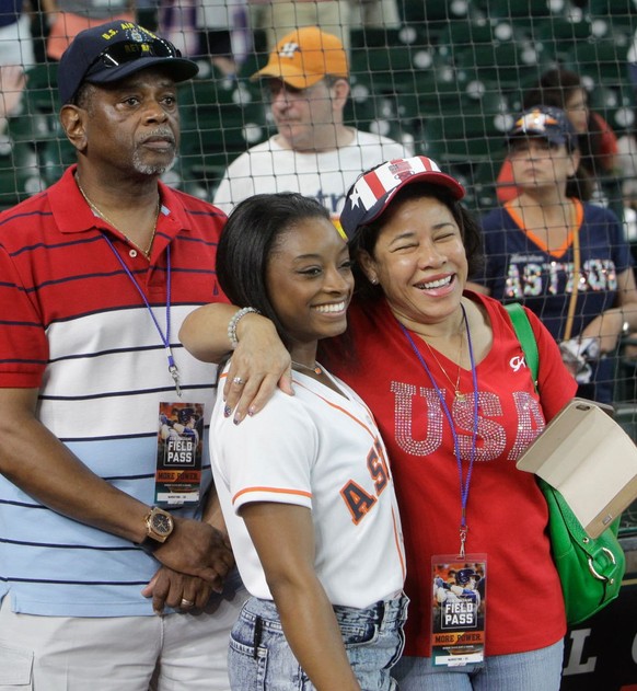 HOUSTON, TEXAS - JULY 4: Simone Biles, of Spring, who will participate in the upcoming Olympic Games in Rio, with her father, Ron Biles, and mother, Nellie Biles, as they wait for her ceremonial first ...