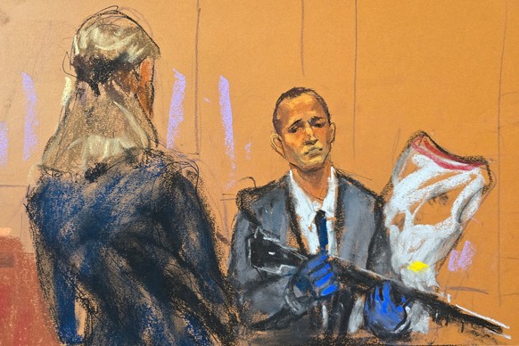 Prosecutor Madison Smizer questions Homeland Security Investigations Special Agent Gerard Gannon as he holds an evidence bag of the upper receivers of AR-15 rifles recovered during a search, at Sean & ...