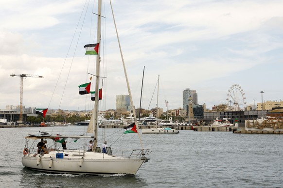 epa12340119 A ship displaying Palestinian flags during the flotilla?s departure from the port in Barcelona, northeastern Spain, 31 August 2025. The Flotilla Global Sumud departed from Barcelona to Gaz ...