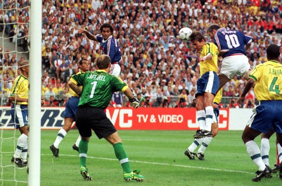 Zinedine Zidane of France, 2nd right 10, heads home the opening goal past Brazilian goalkeeper Taffarel, 1, during the final of the soccer World Cup 98 between Brazil and France at the Stade de France ...