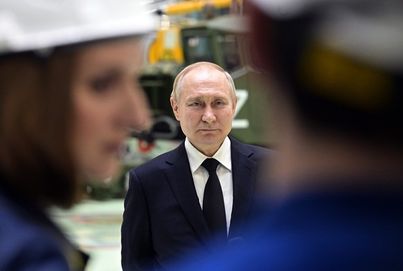 epa10413817 Russian President Vladimir Putin looks on during his visit to the JSC North-Western Regional Center of the Almaz-Antey Concern-Obukhov plant, on the 80th anniversary of the Leningrad siege ...