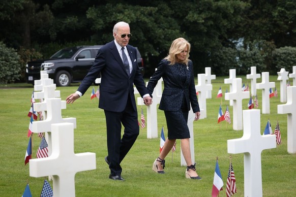 COLLEVILLE-SUR-MER, FRANCE - JUNE 06: U.S. President Joe Biden reaches out to touch a U.S. soldier's tombstone as he and first lady Jill Biden tour the Normandy American Cemetery on the 80th anni ...