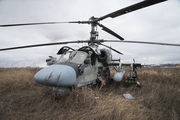 A Russian Ka-52 helicopter gunship is seen in the field after a forced landing outside Kyiv, Ukraine, Thursday, Feb. 24, 2022. Russia on Thursday unleashed a barrage of air and missile strikes on Ukra ...