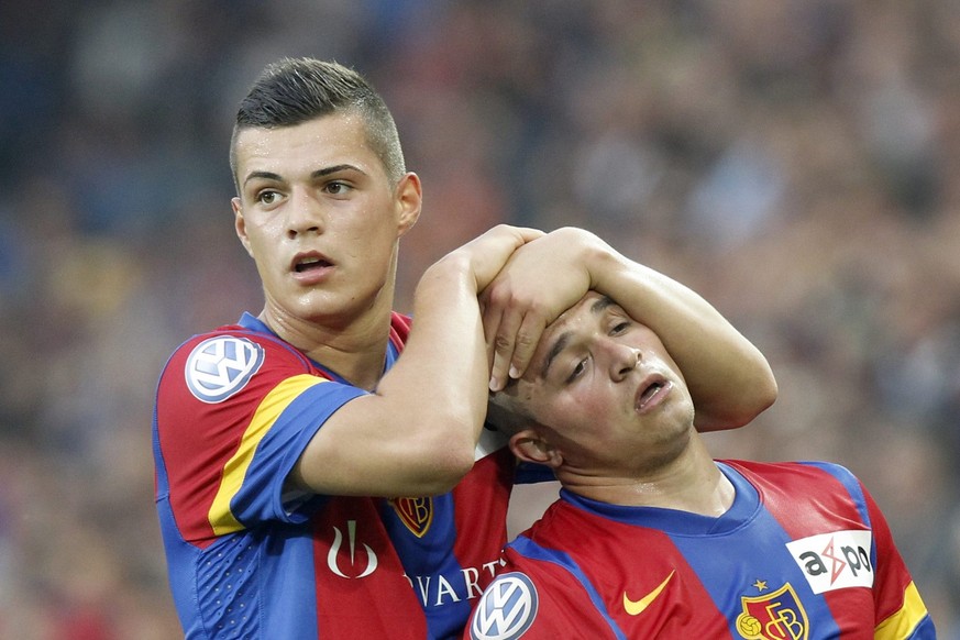 Basel&#039;s Granit Xhaka, left, holds Xherdan Shaqiri, right, during the Super League soccer match between FC Basel and BSC Young Boys at the St. Jakob-Park stadium in Basel, Switzerland, on Wednesda ...