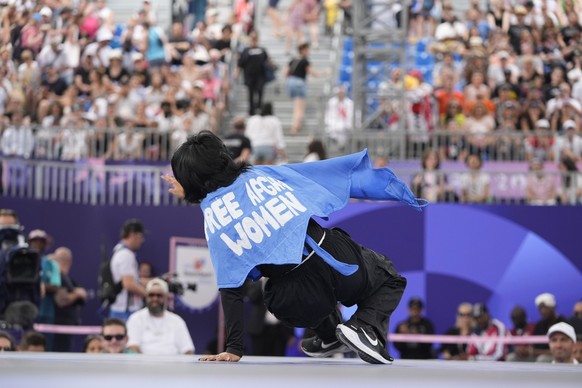 Refugee Team&#039;s Manizha Talash, known as Talash wears a cape which reads &quot;free Afghan women&quot; as she competes during the B-Girls Pre-Qualifier Battle of the breaking competition at La Con ...