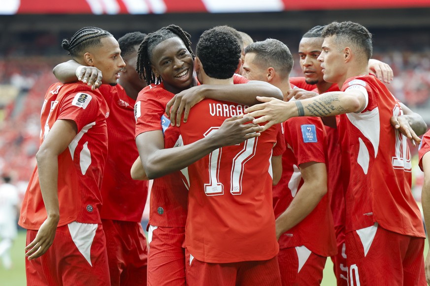 Switzerland's Ruben Vargas, third from left, celebrates with Switzerland's Johan Manzambi, second from left, and the Swiss team after scoring the first goal during the World Cup Group B socc ...