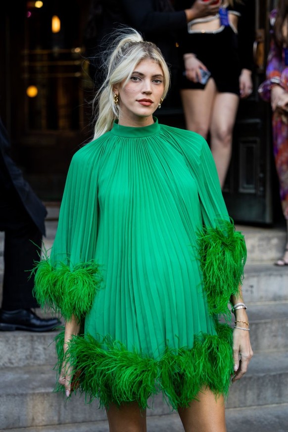 BERLIN, GERMANY - DECEMBER 10: Sonia Lyson is seen wearing black, oval-shaped Vehla sunglasses. Her outfit is cream-colored, consisting of a long, oversized faux fur coat that reaches her ankles. Unde ...