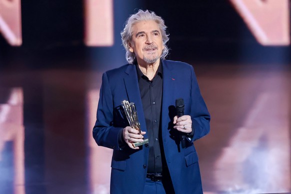 PARIS, FRANCE - FEBRUARY 10: Serge Lama receives the &#039;Victoire d&#039;Honneur&#039; award from singer Calogero during the 38th &quot;Les Victoires De La Musique&quot; Award Ceremony At La Seine M ...