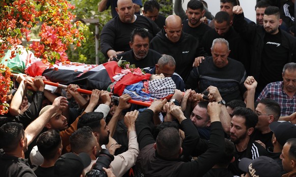 epa11279907 Mourners carry the body of 17-year-old Yazan Ishtayeh during his funeral at Salem village, near the West Bank city of Nablus, 15 April 2024, after he was killed in an Israeli raid. At leas ...