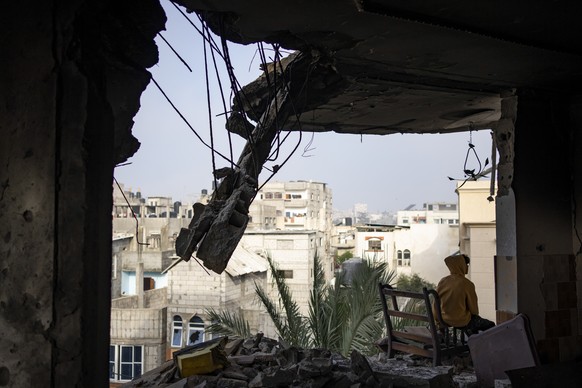 A Palestinian sits in his house destroyed in an Israeli strike in Rafah, Gaza Strip, Saturday, Feb.10, 2024. (AP Photo/Fatima Shbair)
