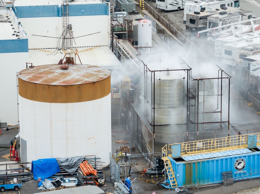 Water is sprayed on a damaged tank at GKN Aerospace in Garden Grove, Calif., on Sunday, May 24, 2026, after the tank containing a chemical used to make plastic parts overheated Thursday. (AP Photo/Eth ...