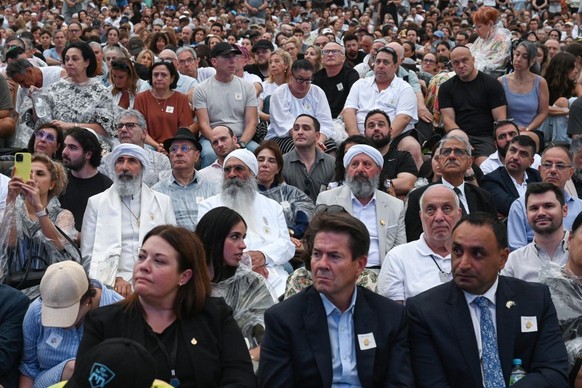 Mourners attend the memorial held for the victims of a shooting at Bondi Beach in Sydney on December 21, 2025. A father and his son are accused of spraying bullets into the family-thronged Hanukkah ce ...