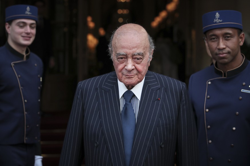 FILE - Egyptian businessman and Ritz hotel owner Mohammed Al Fayed poses with his hotel staff in Paris, Monday, June 27, 2016. (AP Photo/Kamil Zihnioglu, File)