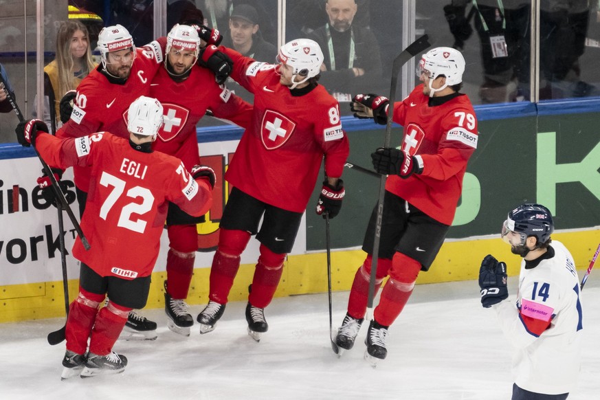 Switzerland's Nino Niederreiter, 3rd left, celebrates his goal to 1:0 with his teammates, during the 2026 IIHF Men's Ice Hockey World Championship preliminary round group A game between Swit ...