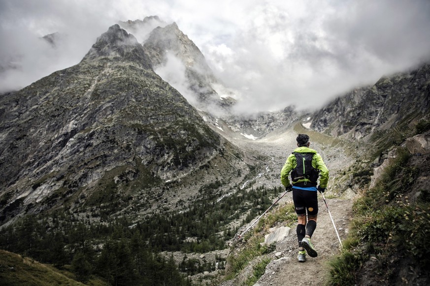 A competitor runs at the Grand Col Ferret as he competes in the 170km Ultra-Trail of Mont-Blanc (UTMB) race, near Courmayeur, Italy, Saturday, Sept 1, 2018. Set up in a breathtaking setting in the hea ...