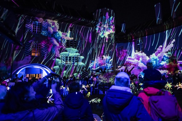 KEYPIX - Spectators watch "Magic Drops" by Swiss artist and videographer Adrian Scherzinger, during the 10th edition of the Murten Light Festival, in Murten, Switzerland, Thursday, January 2 ...