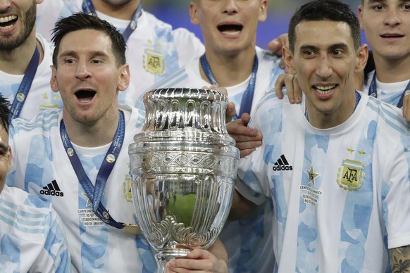 Argentina&#039;s Lionel Messi, left, and teammate Angel Di Maria celebrate with teammates after beating 1-0 Brazil in the Copa America final soccer match at the Maracana stadium in Rio de Janeiro, Bra ...