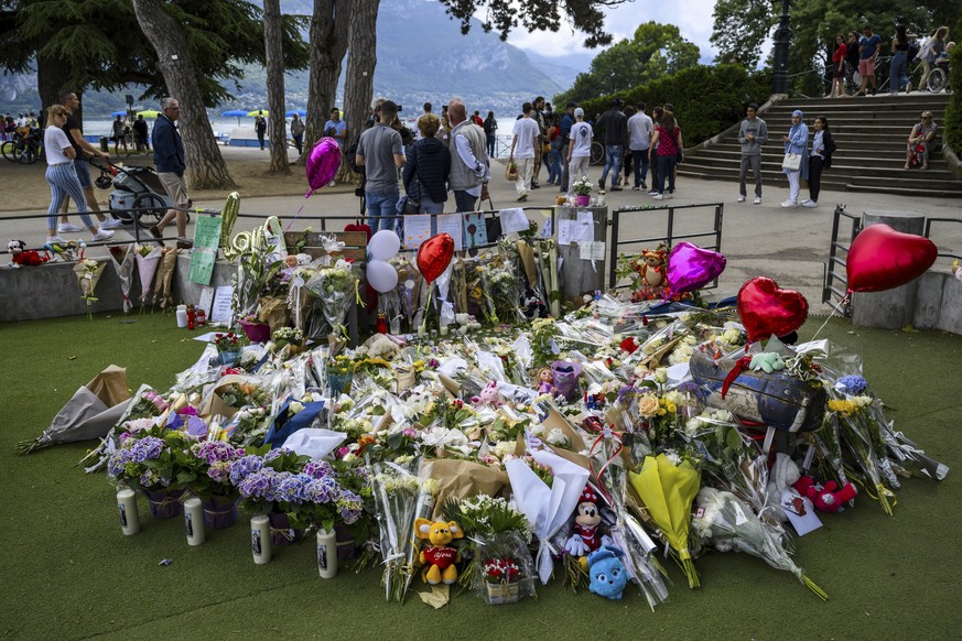 Flowers are laid down at a children&#039;s playground in Annecy, France, Saturday, June 10, 2023 following a knife attack on Thursday, June 8, 2023. French judges have handed preliminary charges of at ...