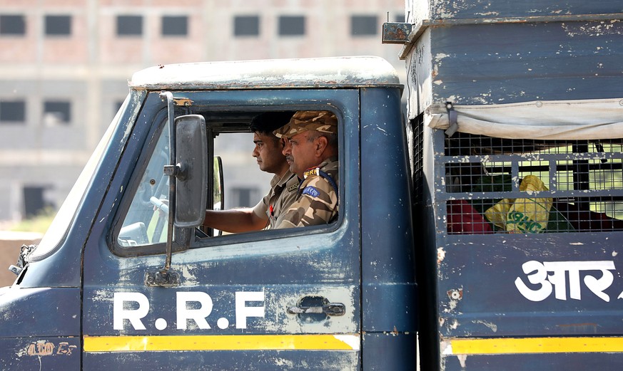 epa12888663 Police personnel patrol the area near the Phase 2 Hosiery Complex after workers' protests erupted in the industrial township of Noida, Uttar Pradesh, India, 14 April 2026. According t ...