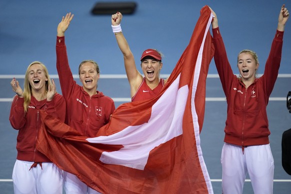 Switzerland&#039;s players Jil Teichmann, Viktorija Golubic, Belinda Bencic and Simona Waltert, from left, celebrates after defeating Australia to win the Billie Jean King Cup tennis finals, at the Em ...