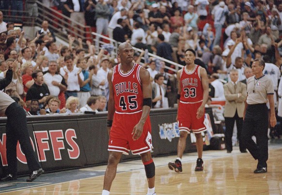 Chicago Bulls guard Michael Jordan (45) and forward Scottie Pippen (33) walk back to the bench during a timeout with 1.5 seconds left and the Orlando Magic leading 94-91 during their first playoff gam ...