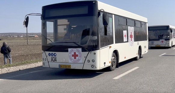 This image taken from video provided by the International Committee of the Red Cross (ICRC) shows a convoy of buses and private cars traveling from Mariupol to Berdansk, a city to the west, up to Zapo ...