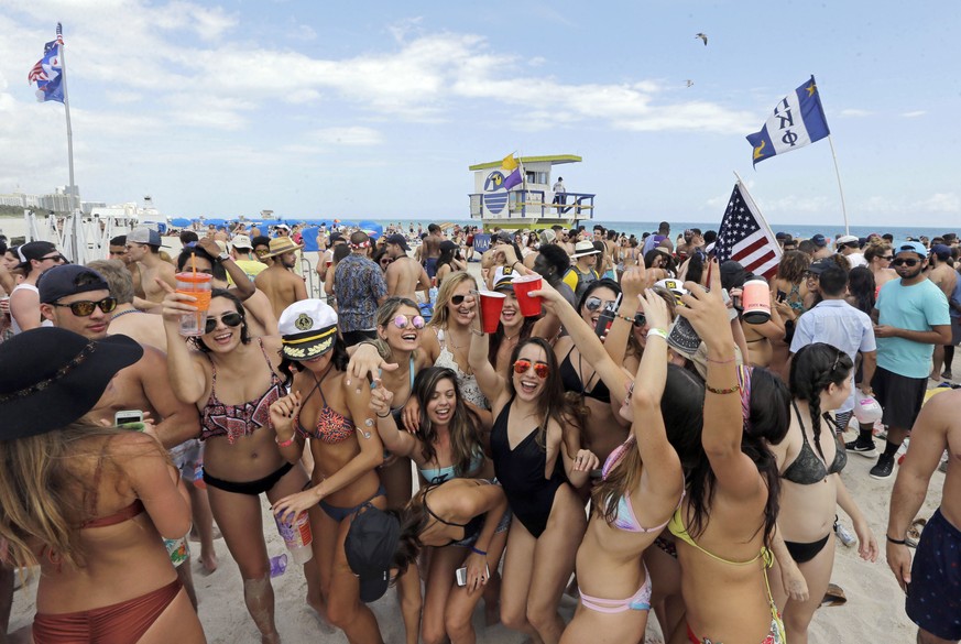 FILE - In this Monday, March 14, 2016, file photo, college students have fun during their spring break in South Beach, at Miami Beach, Fla. The mayor of Miami Beach is proposing changes to the South B ...