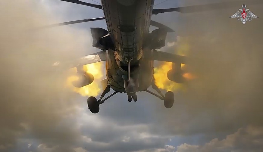 In this photo taken from video released by the Russian Defense Ministry on Wednesday, Aug. 21, 2024, Russian Mi-35M helicopter fires towards Ukrainian positions at an undisclosed location in the Russi ...