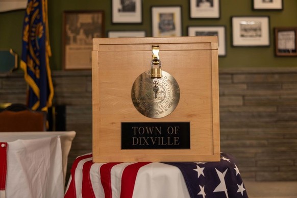 DIXVILLE NOTCH, NEW HAMPSHIRE - JANUARY 22: The Dixville ballot box is displayed in front of voting booths in the Tillotson House during preparations for midnight voting on January 22, 2024 in Dixvill ...