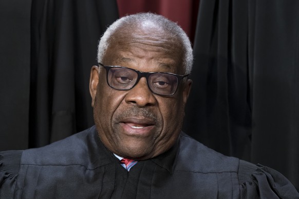 Associate Justice Clarence Thomas joins other members of the Supreme Court as they pose for a new group portrait, at the Supreme Court building in Washington, Friday, Oct. 7, 2022. Justice Thomas was  ...