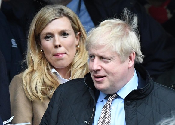 epa08277350 British Prime Minister, Boris Johnson (R) and his partner Carrie Symonds (L) during the Six Nations rugby match between England and Wales held at Twickenham stadium in London, Britain, 07  ...
