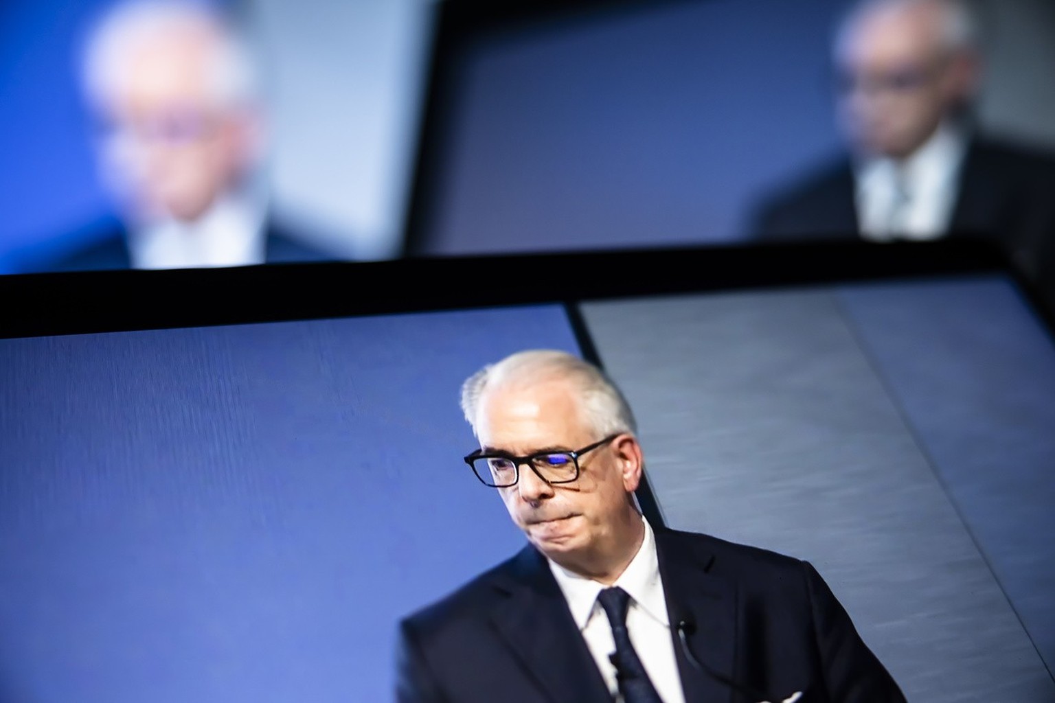 Swiss bank Credit Suisse CEO Ulrich Koerner is seen on screens presenting the quarterly report and the strategy and transformation plan for the bank taken from a webcast streaming in Zurich, Switzerla ...