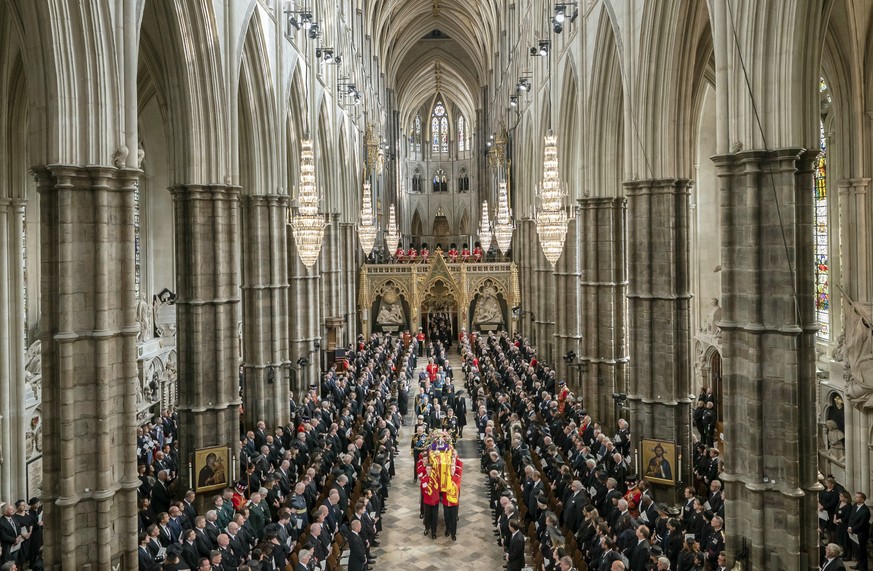 King Charles III, Camilla, the Queen Consort and members of the Royal family follow behind the coffin of Queen Elizabeth II, draped in the Royal Standard with the Imperial State Crown and the Sovereig ...