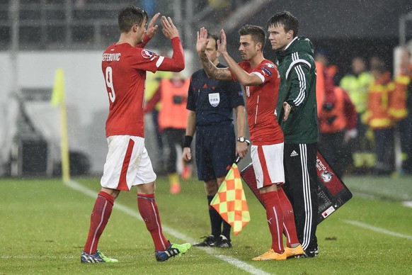 Switzerland's Marco Schoenbaechler, right, enters the game, and claps hands with Haris Seferovic, during the UEFA EURO 2016 group E qualifying match Switzerland against Lithuania at the AFG Arena in S ...