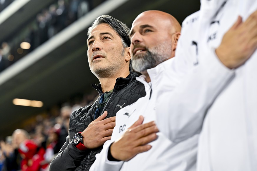 epa11661161 Switzerland&#039;s head coach Murat Yakin (L) and assistant coach Giorgio Contini sing the national anthem ahead of the UEFA Nations League Group D soccer match between Switzerland and Den ...