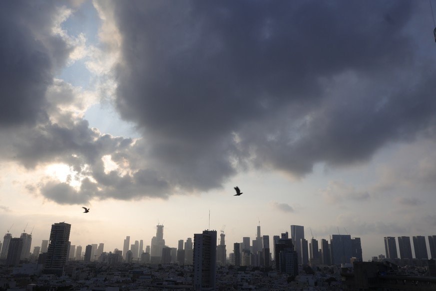 epa12192288 Birds fly at sunrise above the Tel Aviv skyline amid the Iranian ballistic missile threat in Tel Aviv, Israel, 23 June 2025. Israel and Iran have been exchanging fire since Israel attacked ...