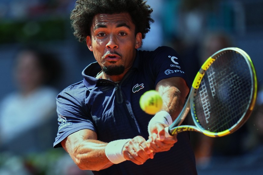 France's Arthur Fils returns the ball to Italy's Jannik Sinner during their men's singles semifinal match at the Madrid Open tennis tournament in Madrid, Spain, Friday, May 1, 2026. (AP ...