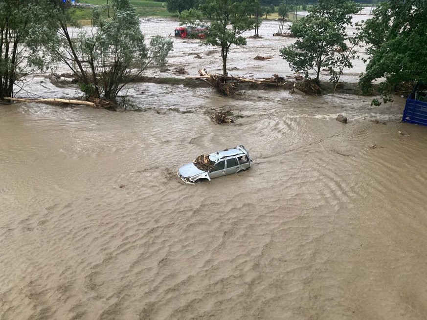 epa10043067 A handout photo made available by the Austrian Federal Police in Carinthia (Kaernten) shows a flooded car after heavy rains and a mudslide in the southern region of Carinthia, Austria, 29 ...