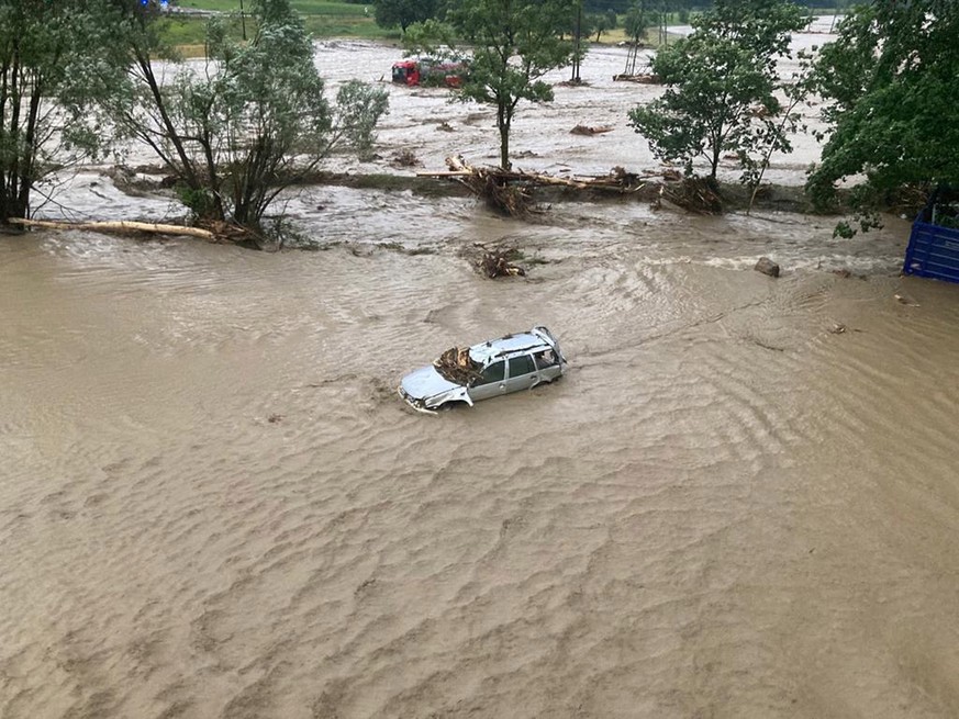 epa10043067 A handout photo made available by the Austrian Federal Police in Carinthia (Kaernten) shows a flooded car after heavy rains and a mudslide in the southern region of Carinthia, Austria, 29  ...