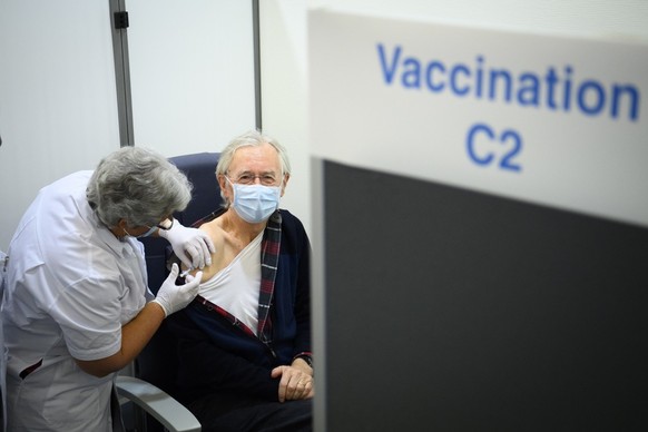 A nurse administers the Pfizer-BioNTech COVID-19 vaccine during the vaccinations against the coronavirus disease (COVID-19) on the opening day of the vaccination centers in the canton of Vaud at the U ...