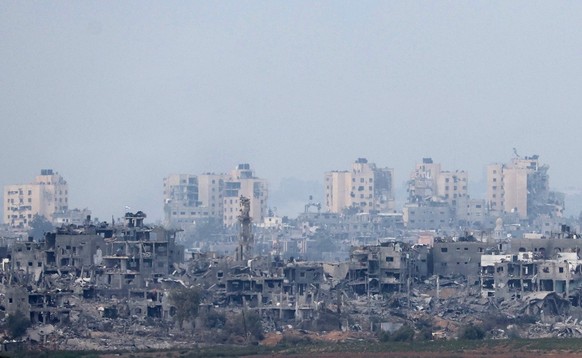 epa10972829 Damaged buildings in the northern Gaza Strip following Israeli airstrikes, as seen from Sderot, Israel, 13 November 2023. More than 11,000 Palestinians and at least 1,200 Israelis have bee ...