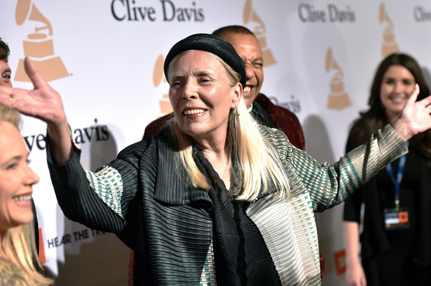 FILE - Joni Mitchell arrives at the 2015 Clive Davis Pre-Grammy Gala in Beverly Hills, Calif. Feb. 7, 2015. Joni Mitchell said Friday, Jan. 28, 2022 she seeks to remove all of her music in Spotify in  ...