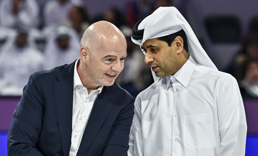 epa12740488 International Association Football Federation (FIFA) President Gianni Infantino (L) and French football club Paris Saint-Germain's Qatari president Nasser al-Khelaifi speak as they wa ...