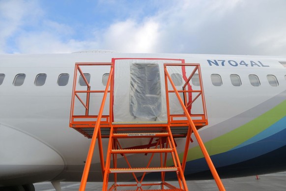 PORTLAND, OREGON - JANUARY 7: In this National Transportation Safety Board (NTSB) handout, plastic covers the exterior of the fuselage plug area of Alaska Airlines Flight 1282 Boeing 737-9 MAX on Janu ...