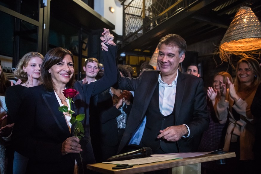 epa09524286 The winner of the left-wing primaries Paris Mayor Anne Hidalgo (L) holds a rose next to French Socialist party general secretary Olivier Faure (R) after the announcement of the results of  ...