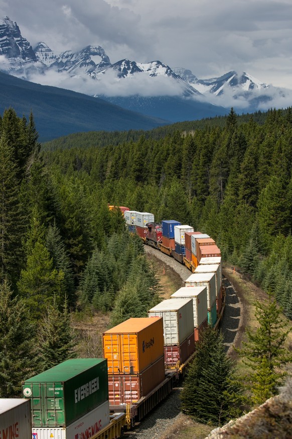 LAKE LOUISE, CANADA - APRIL 23: A Canadian Pacific Railway freight train makes its way westward along the Bow River on April 23, 2016 at Lake Louise, Alberta, Canada. Banff is Canada's oldest Nat ...