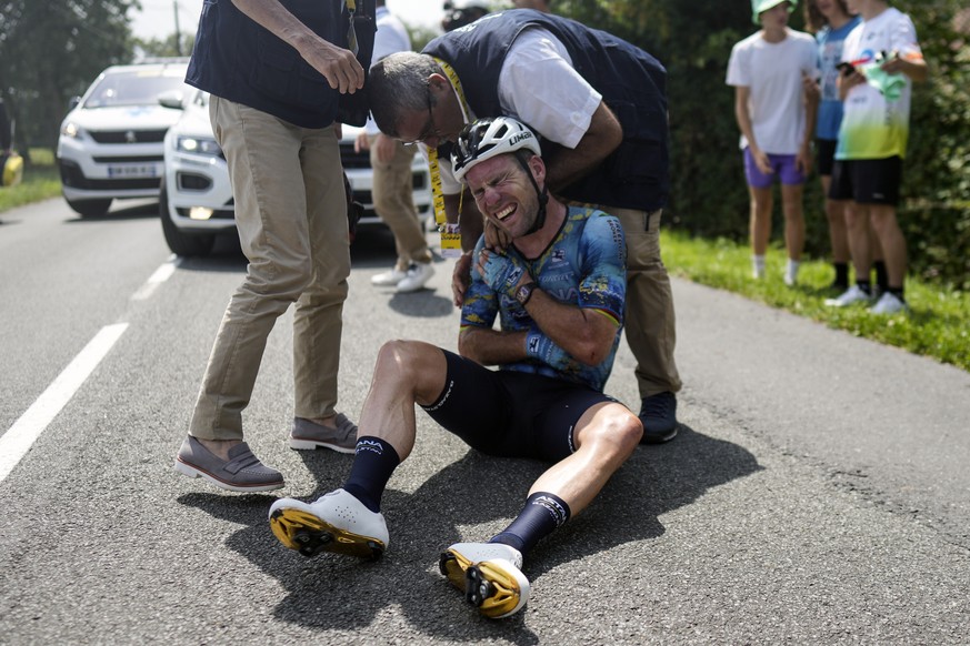 FILE - Britain&#039;s Mark Cavendish grimaces in pain as he receives medical assistance after crashing during the eighth stage of the Tour de France cycling race over 201 kilometers (125 miles) with s ...