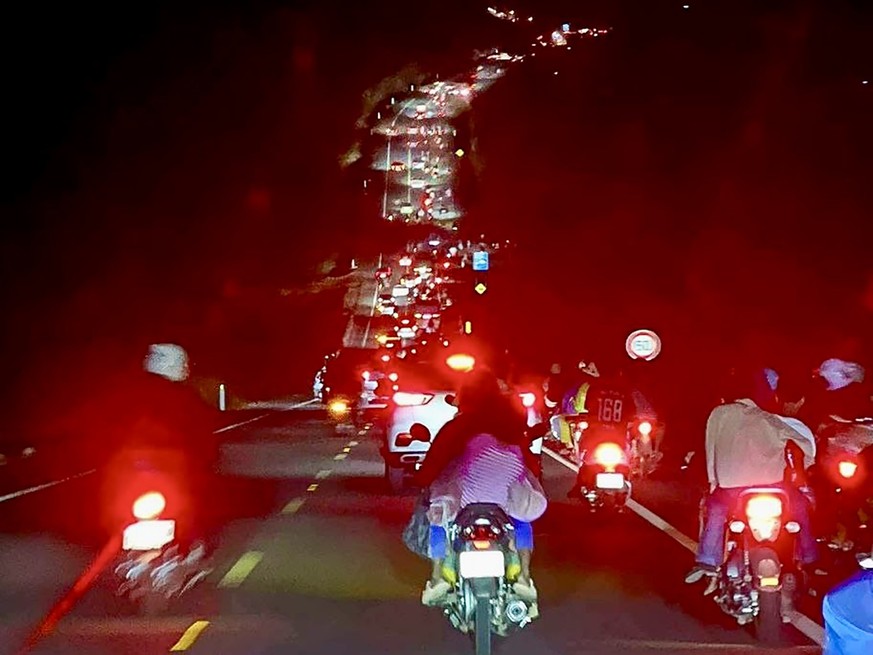 epa12588606 A handout photo made available by Agence Kampuchea Presse (AKP) shows people fleeing from a disputed area along a street in Koh Kong Province, Cambodia, 13 December 2025. The Koh Kong Prov ...