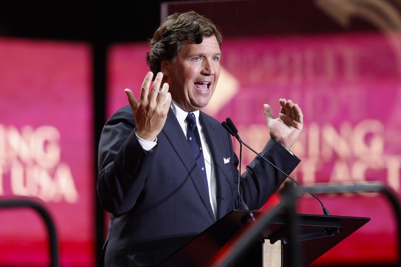 epa12397016 US media personality Tucker Carlson speaks during the public memorial service of political activist Charlie Kirk at State Farm Stadium in Glendale, Arizona, USA, 21 September 2025. Kirk wa ...