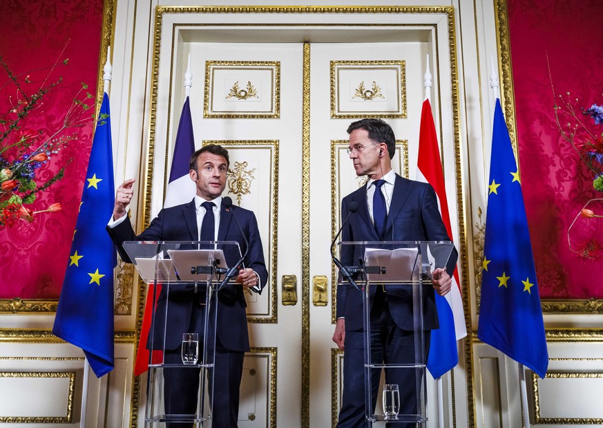 epa10569787 French President Emmanuel Macron (L) and Dutch Prime Minister Mark Rutte (R) give a joint press conference at the official residence of the mayor of Amsterdam, in Amsterdam, The Netherland ...